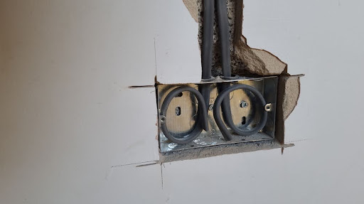 Exposed wiring where hole is cut into the wall