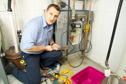 Neighborhood HVAC tech installing furnace.